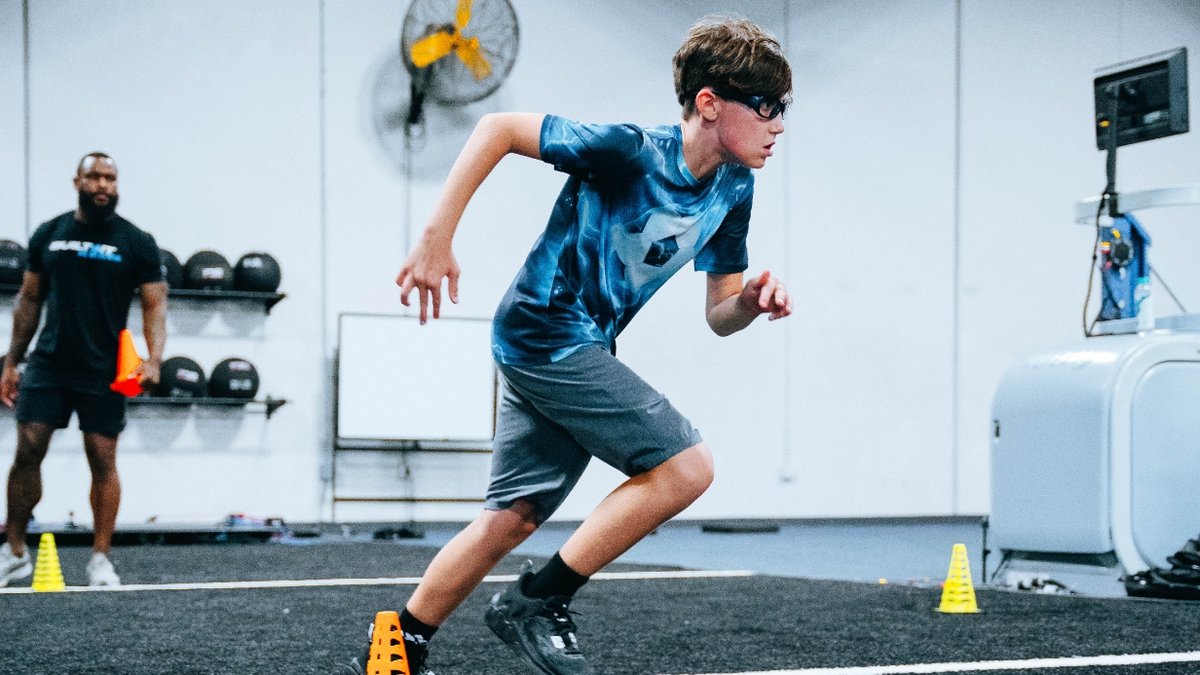Young male teen running at the gym