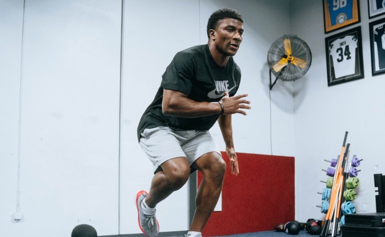 Black male working on conditioning at the gym