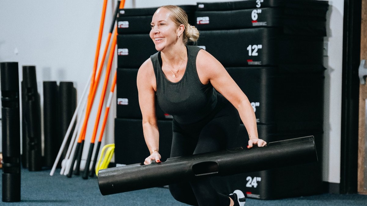 Woman happily working out at the gym